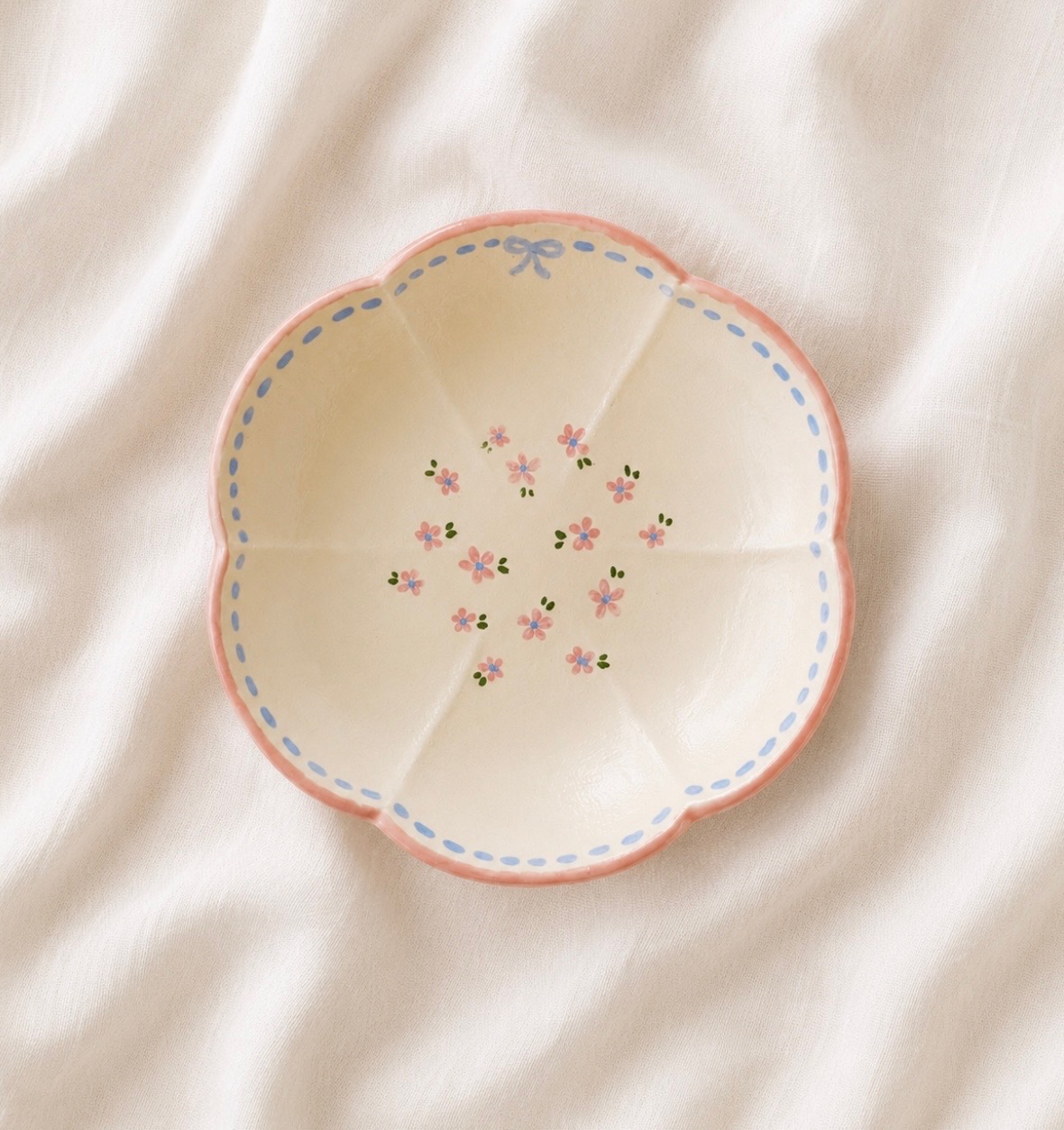 Hand-painted pink scalloped dish with blue dashed border, bow and ditsy florals